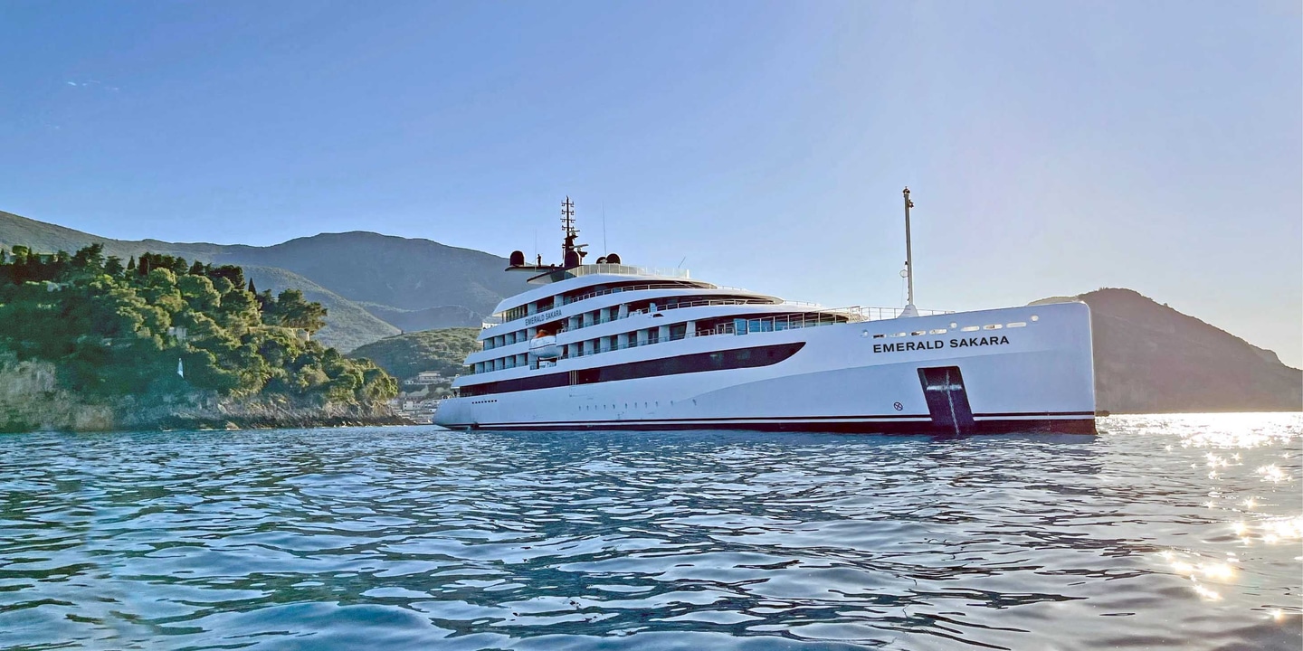 An Emerald Cruises yacht is anchored off Parga, Greece, will the island’s hills and trees seen in the background