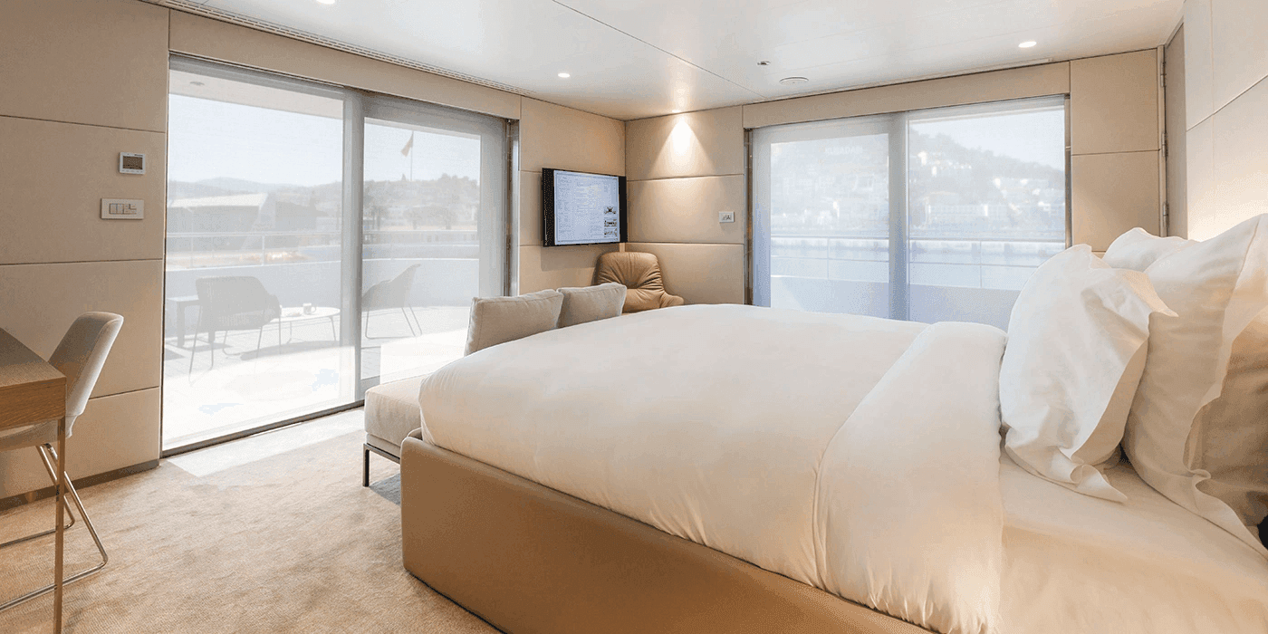 A large and spacious cabin on an Emerald Cruises yacht cruise leading out to both an outdoor terrace and balcony