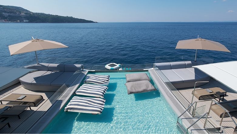 Man swimming in a pool on board a luxury yacht.