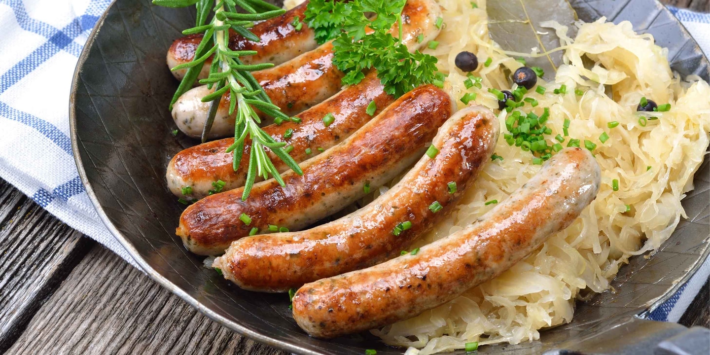 Authentic bratwurst sausages on a plate with potato.