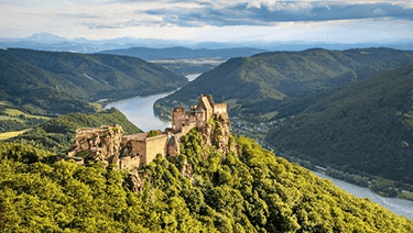 Durnstein Castle on top of a green hill in the Wachau Valley of Austria on the banks of the Danube River