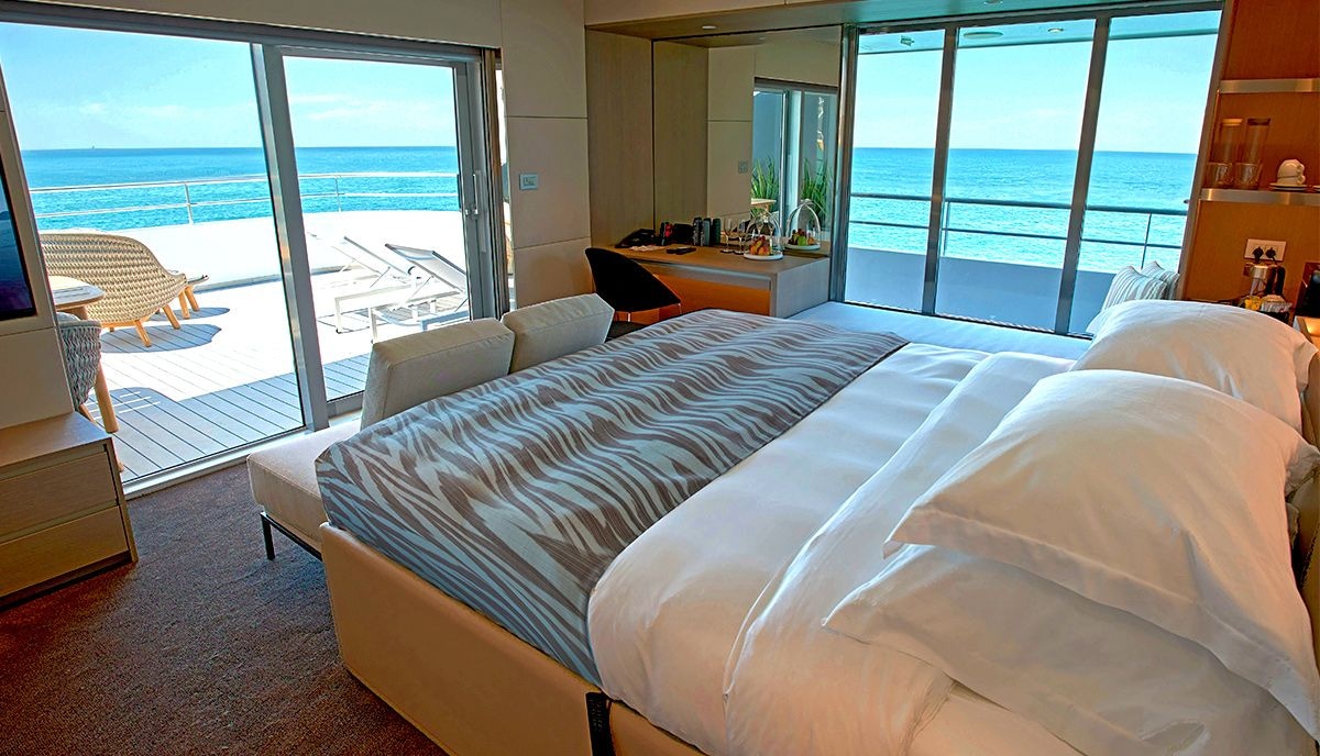 A large and spacious cabin on an Emerald Cruises yacht cruise leading out to both an outdoor terrace and balcony