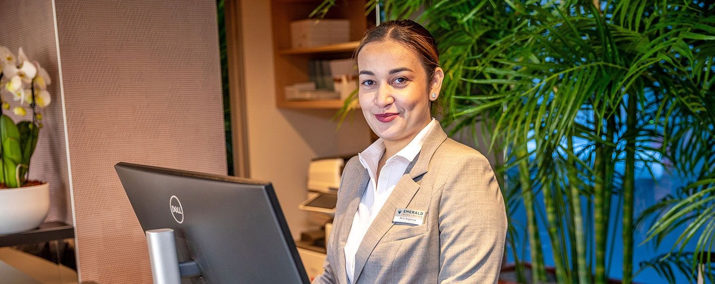 Emerald Cruises crew member welcoming guests at the reception desk