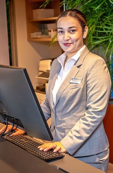 Emerald Cruises crew member welcoming guests at the reception desk
